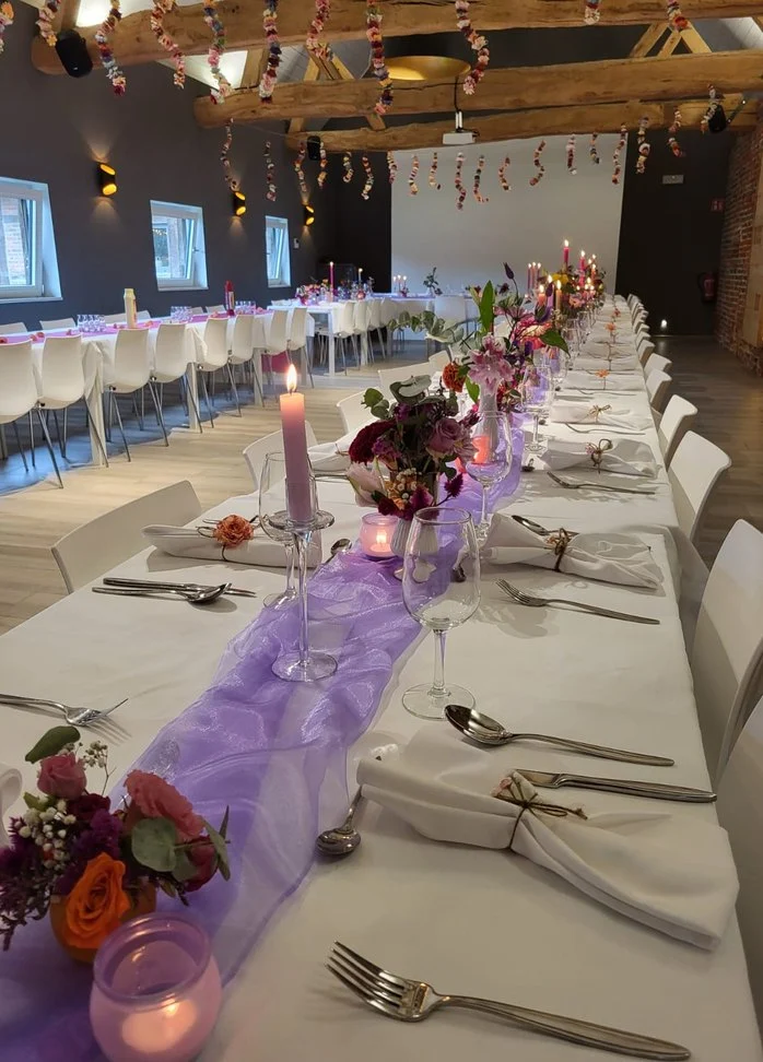Lange gedekte tafel met paarse decoratie